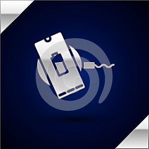 Silver Smartphone charging on wireless charger icon isolated on dark blue background. Charging battery on charging pad