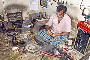 Silver smith at work in his workshop