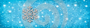Silver snowflake on a blue grunge background with snow texture, banner. Minimar christmas border. Top view, flat lay