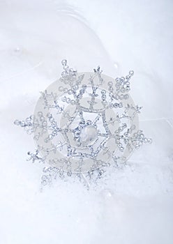 Silver snowflake in snow