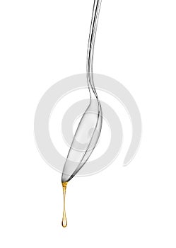 Silver spoon with oil drop isolated on white background