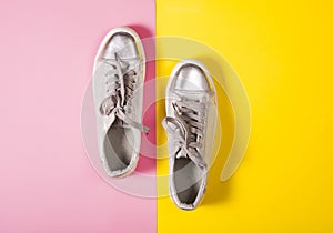 Silver sport boots on retro color background. Fashion concept