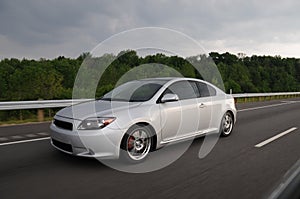 Silver Sports Car speeding on highway