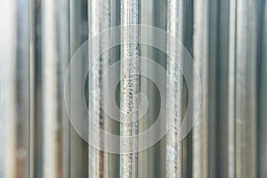 Silver steel metal bar close-up, with unfocused background, industrial concept