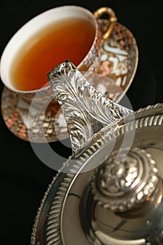 Silver teapot pouring tea