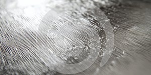 A silver textured surface with a fine, crosshatched pattern, adding a delicate, linear texture