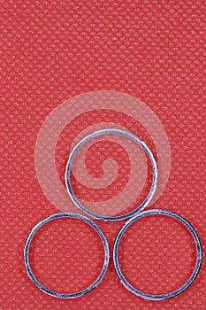 Silver three rings with red background