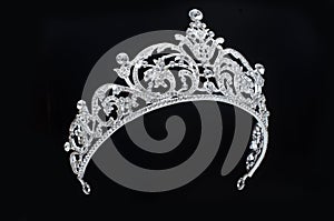 Silver tiara with diamonds on black background