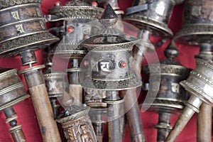 Silver Tibetan prayer wheels on stall at Swayambhu