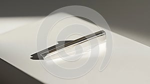 Silver tie is sitting on a white surface