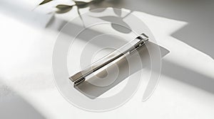 Silver tie is sitting on a white table