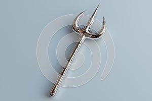 Silver trident on a light gray background