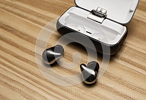 Silver true wireless bluetooth earphones with charging case. Bleach color effect