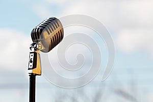 Silver vintage microphone in the studio on outdoor background