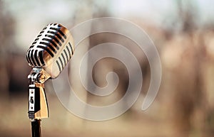Silver vintage microphone in the studio on outdoor background