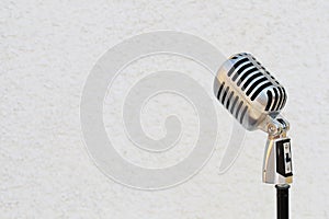 Silver vintage microphone in the studio on white background