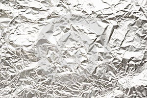 Silver warm tone crumpled foil background with large crease