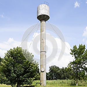 Silver Water Tower among green grass and