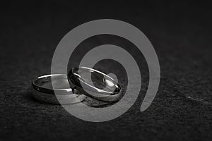 Silver Wedding Rings on a rock background