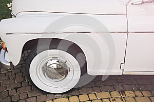 Silver wheel. Old retro car is standing outdoors. Vintage vehicle. Stylish concept automobile