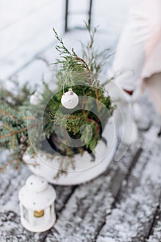 Silver and white christmas ornaments, xmas tree on rustic wood background with sparkle bokeh lights. Merry christmas card. Winter