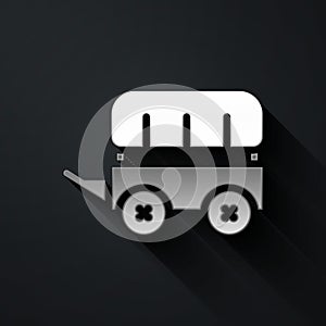 Silver Wild west covered wagon icon isolated on black background. Long shadow style. Vector