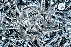 Silver woodscrews macro background, iron screws, steel