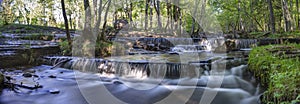 Silverfallet Staircase Waterfall illuminated by low rays of sun