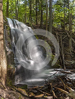 Silverfallet Staircase Waterfall illuminated by low rays of sun