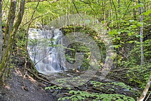 Silverfallet Staircase Waterfall illuminated by low rays of sun