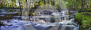 Silverfallet Staircase Waterfall illuminated by low rays of sun