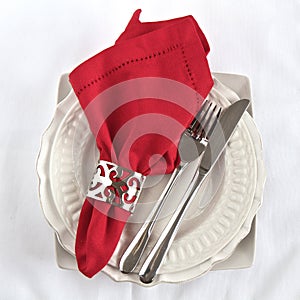 SIlverware as a table setting with red napkin photo