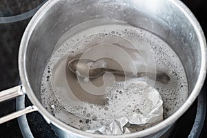 Silverware in boiling solution of baking soda