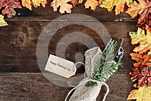 Silverware and Card over Wooden Background