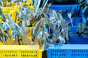 Silverware and cutlery in colorful palstic ocntainer in an industrial restaurant kitchen photo