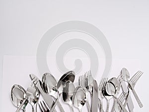 Silverware forks spoons knives cutlery on a white background