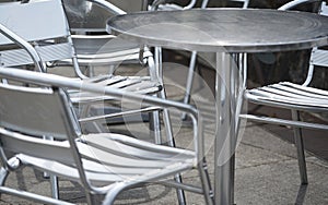 Silvery metal chairs and tables