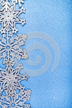 Silvery snowflakes on a blue background.