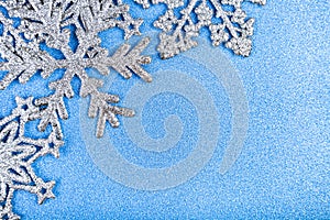 Silvery snowflakes on a blue background.