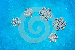 Silvery snowflakes on a blue grunge background. Christmas composition. Top view, flat lay