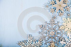 Silvery snowflakes on a wooden background.