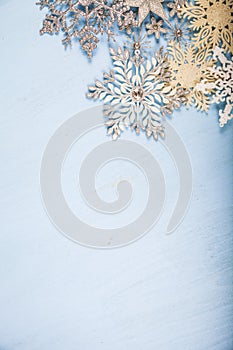 Silvery snowflakes on a wooden background.