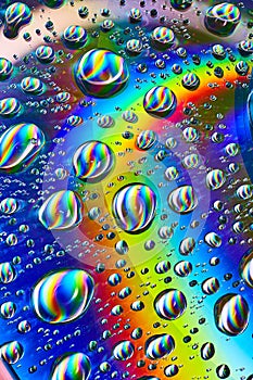 Silvery swirling water drops in cosmic rainbow Saturn ring in psychedelic background asset