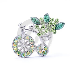 Silwer brooch bicycle with gems and flowers isolated on white photo