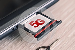 SIM card labeled 5g. Replacing a SIM card in mobile phone with high-speed Internet