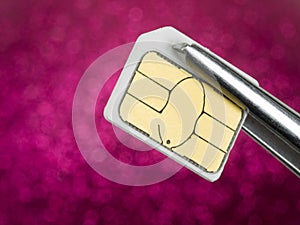 Sim card on tweezers