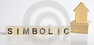 SIMBOLIC -Wooden Blocks With A Miniature House on white background