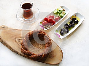 Simit bagel with sesame, black tea and Turkish breakfast photo