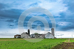 A simple Amish farm house with 2 silos in rural Pennsylvania, Lancaster County, PA, USA