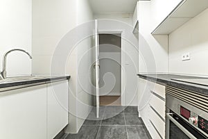 Simple apartment kitchen with newly installed white cabinets,